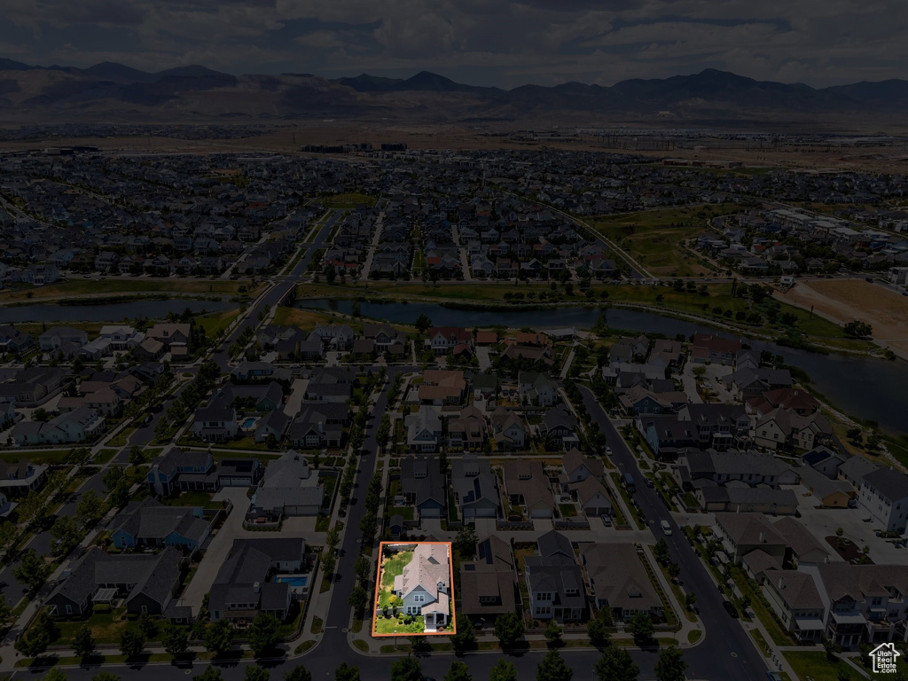 Aerial view of residential area with property parcel outlined and a water and mountain view