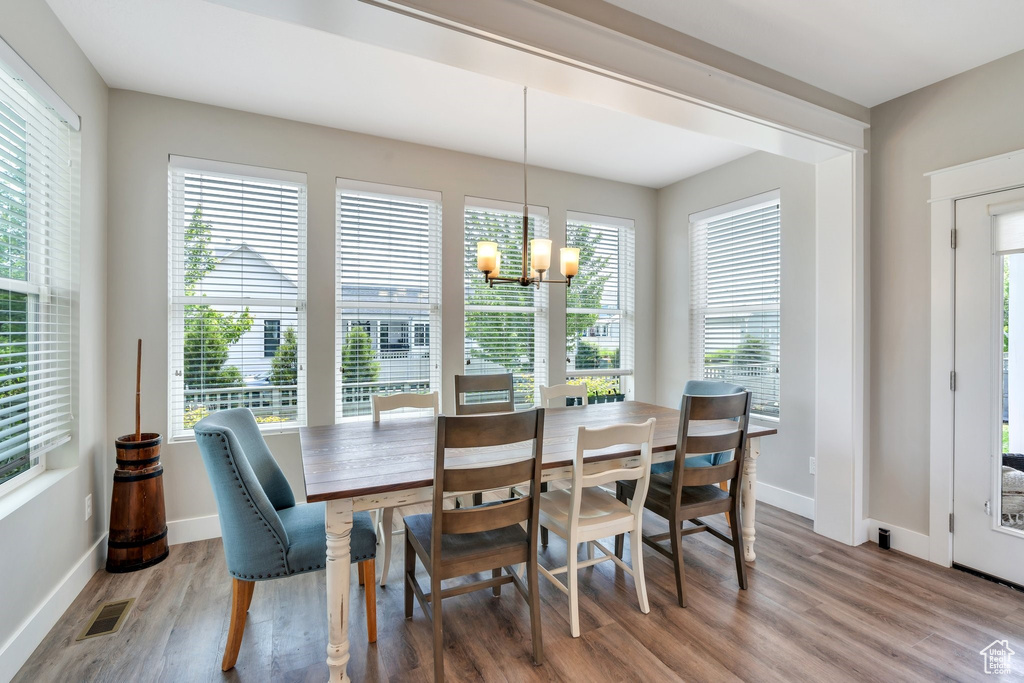 Dining room with a chandelier and wood finished floors