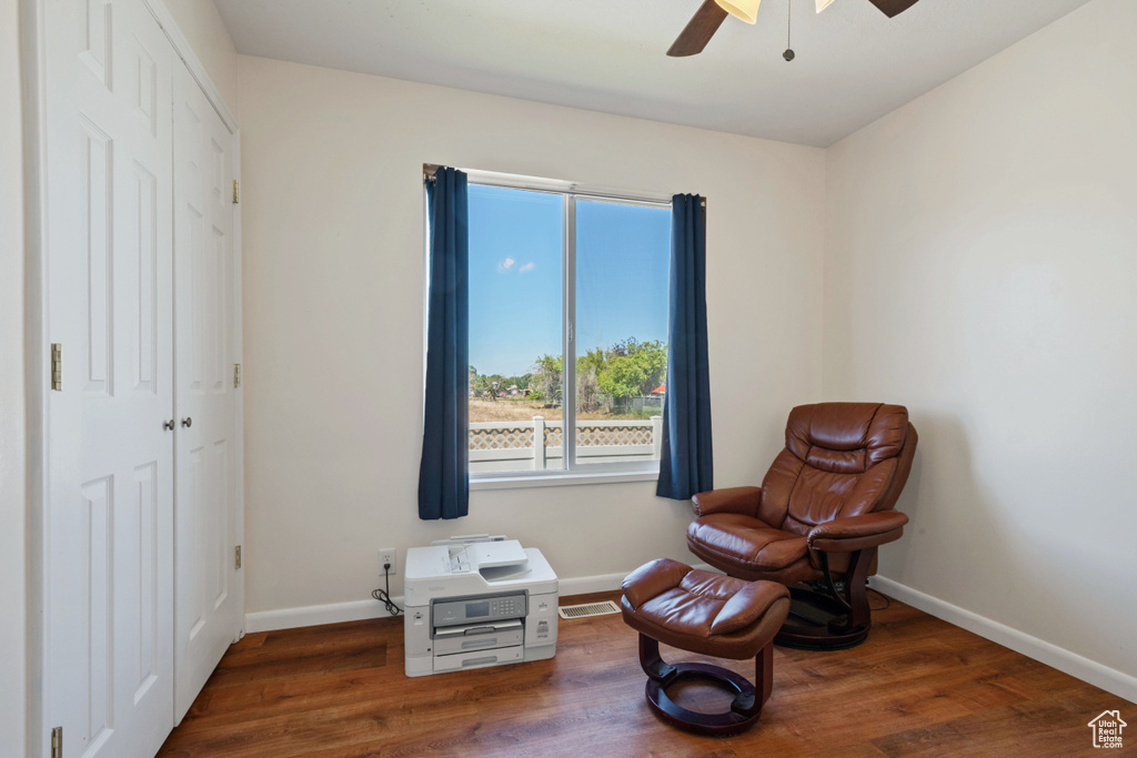 Living area with a ceiling fan and wood finished floors