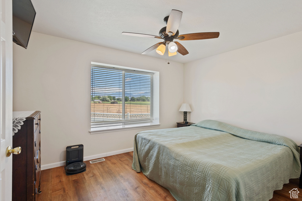 Bedroom featuring wood finished floors and a ceiling fan