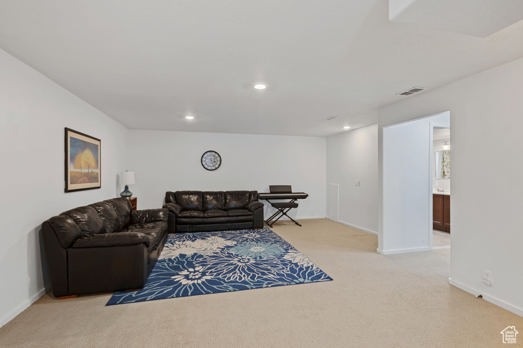 Living area featuring light carpet and recessed lighting