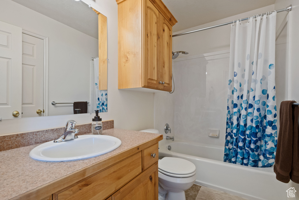 Full bath featuring vanity and shower / bath combo with shower curtain