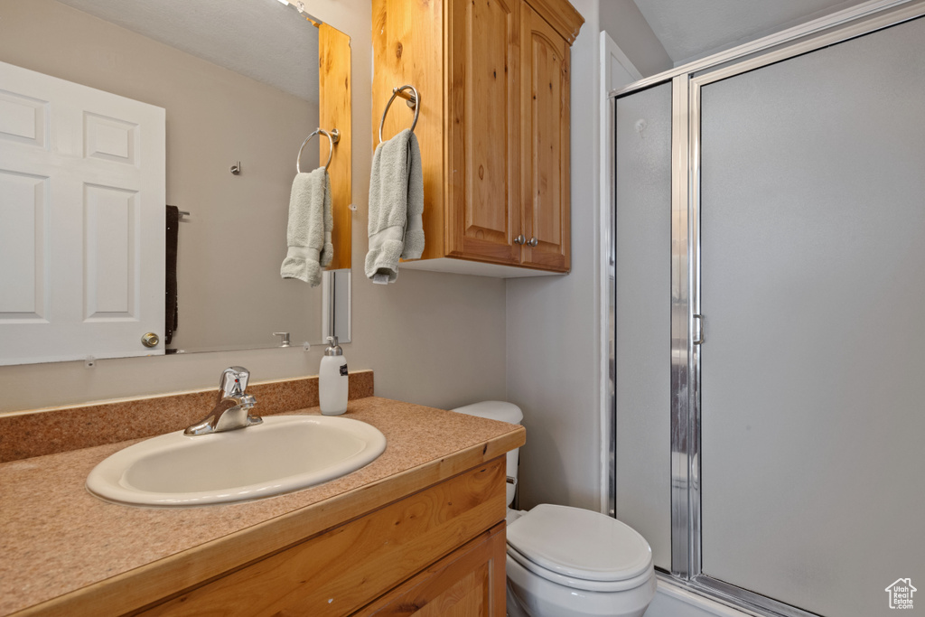 Bathroom featuring a shower stall and vanity