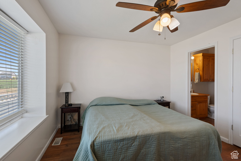 Bedroom featuring wood finished floors, connected bathroom, and ceiling fan