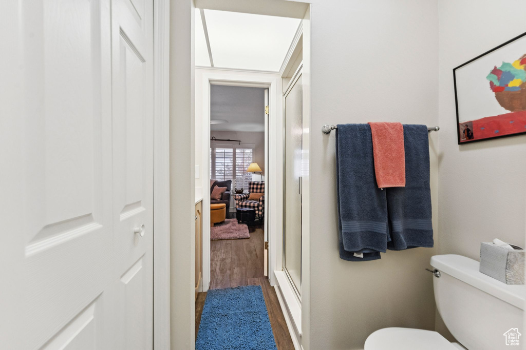 Bathroom with wood finished floors and toilet