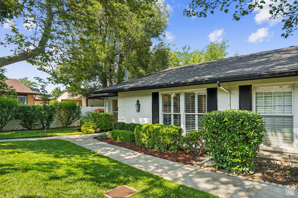 View of front of property featuring brick siding and a shingled roof
