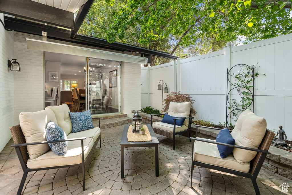 Fenced backyard with a patio area, outdoor lounge area, and a sunroom