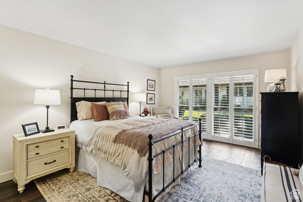 Bedroom featuring access to outside and wood finished floors