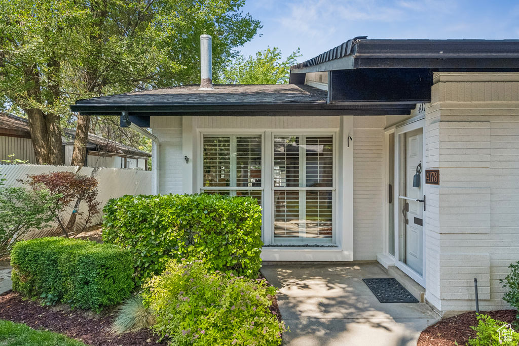 View of exterior entry with brick siding