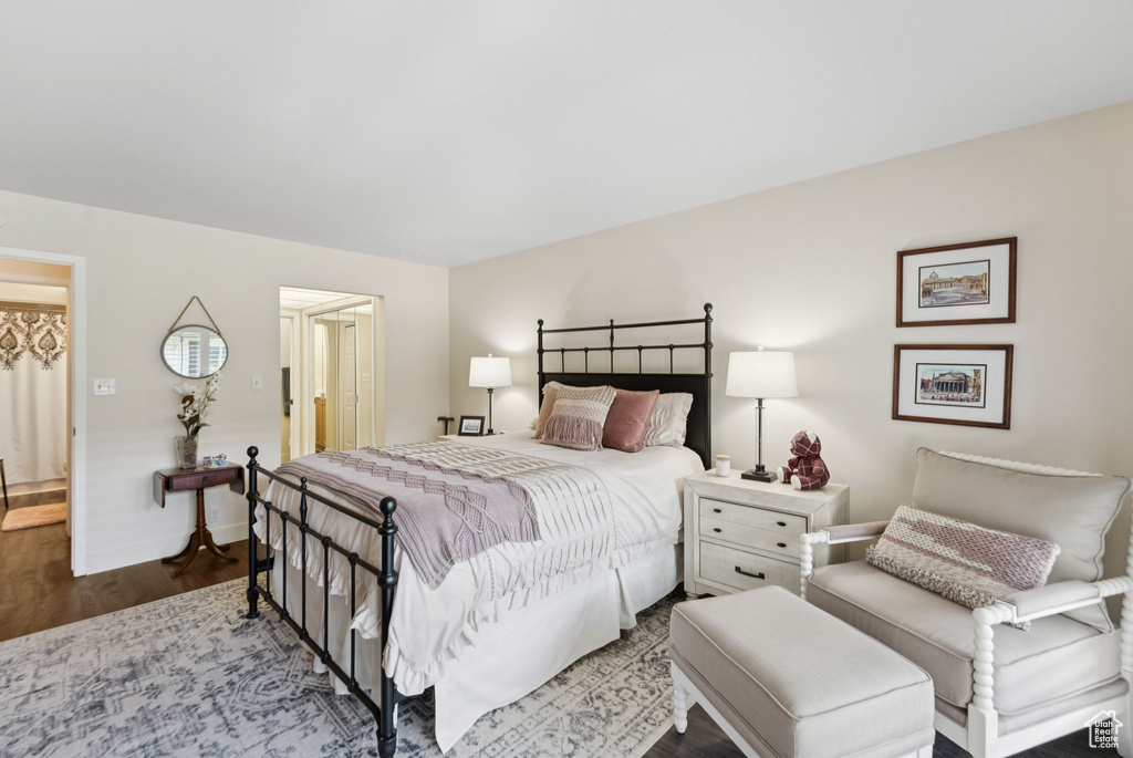 Bedroom featuring wood finished floors and baseboards