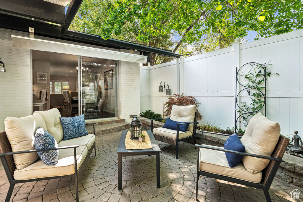 Fenced backyard with an outdoor living space and a patio