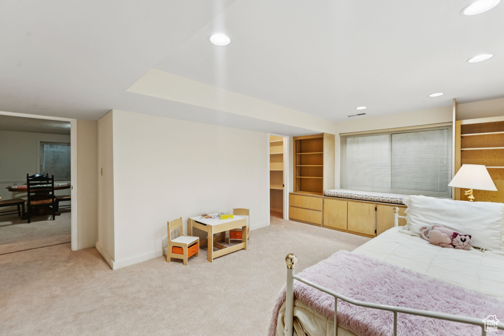 Bedroom featuring light colored carpet, baseboards, and recessed lighting