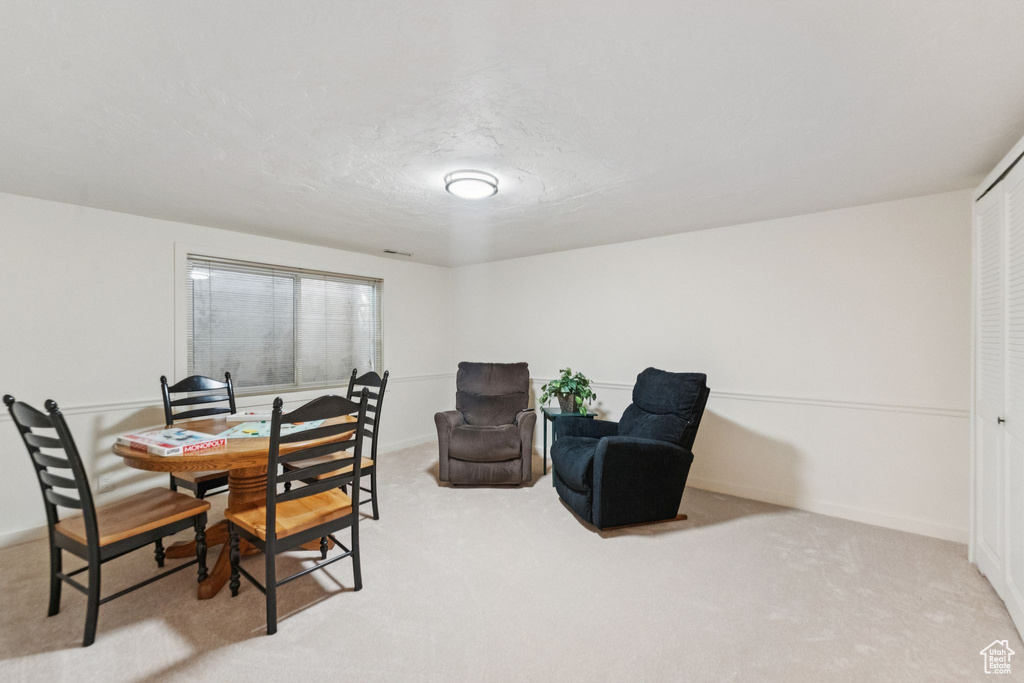 Carpeted dining space featuring baseboards