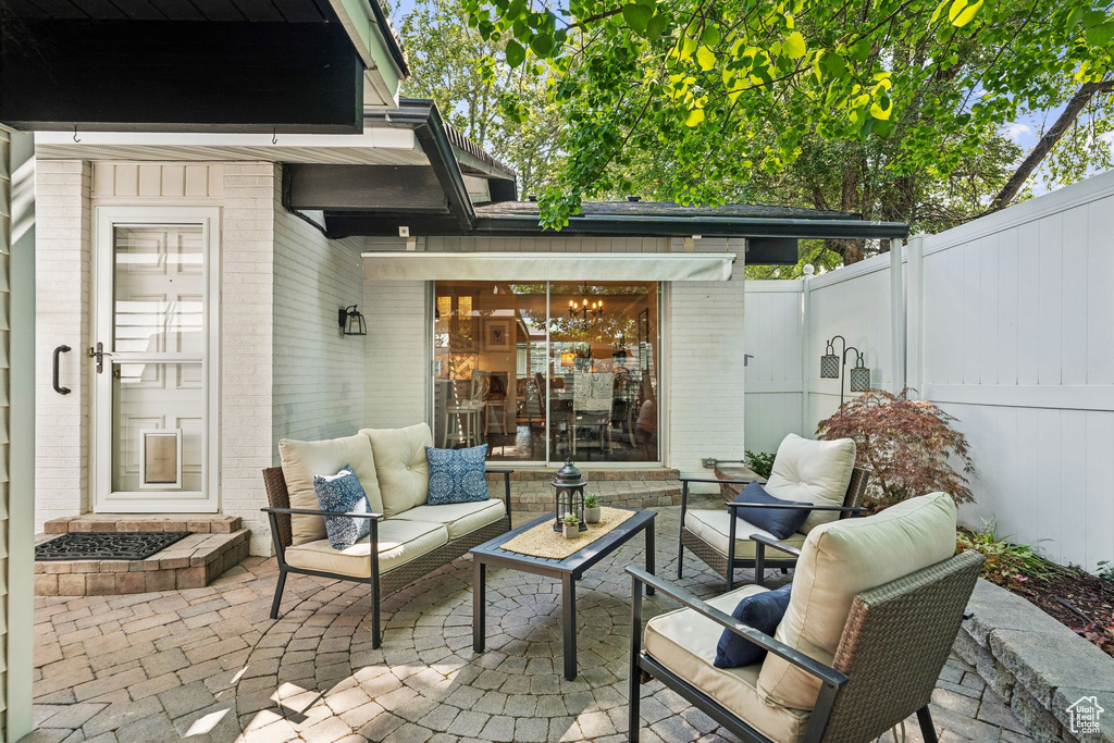 Fenced backyard with a patio and outdoor lounge area