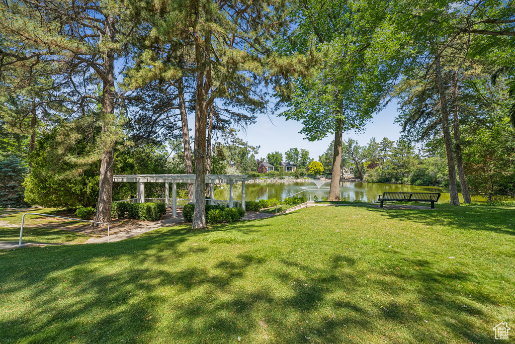 View of green lawn featuring a water view