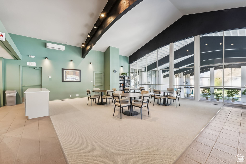 Dining space with carpet flooring, tile patterned flooring, and a wall mounted AC