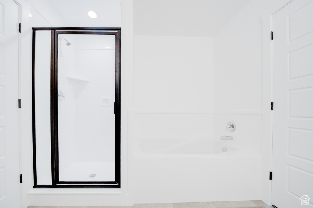 Full bathroom with a shower stall, a garden tub, and recessed lighting