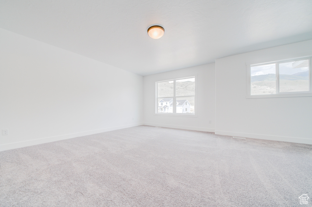 Spare room featuring light colored carpet