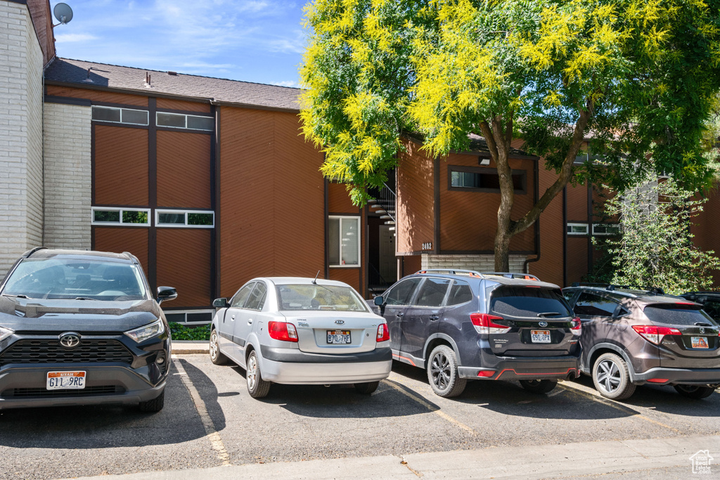 View of property with uncovered parking
