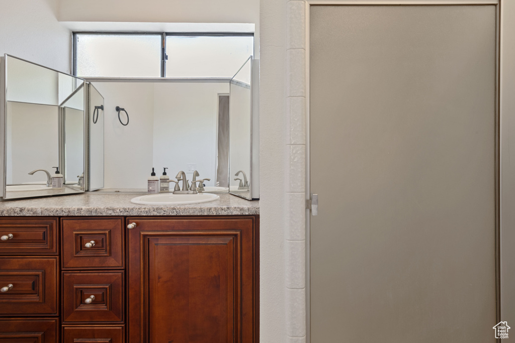 Bathroom featuring double vanity and a shower