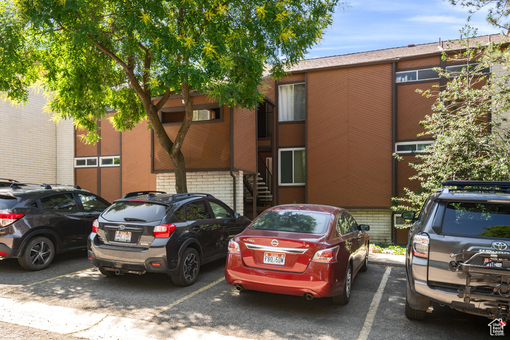View of property featuring uncovered parking