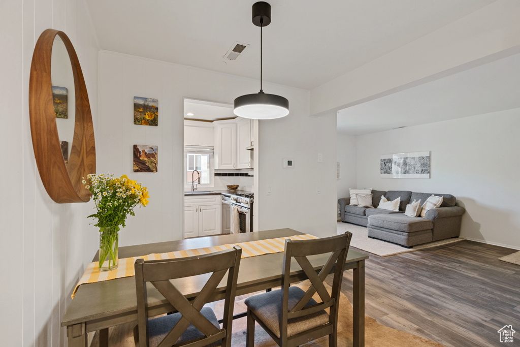 Dining room featuring dark wood-type flooring