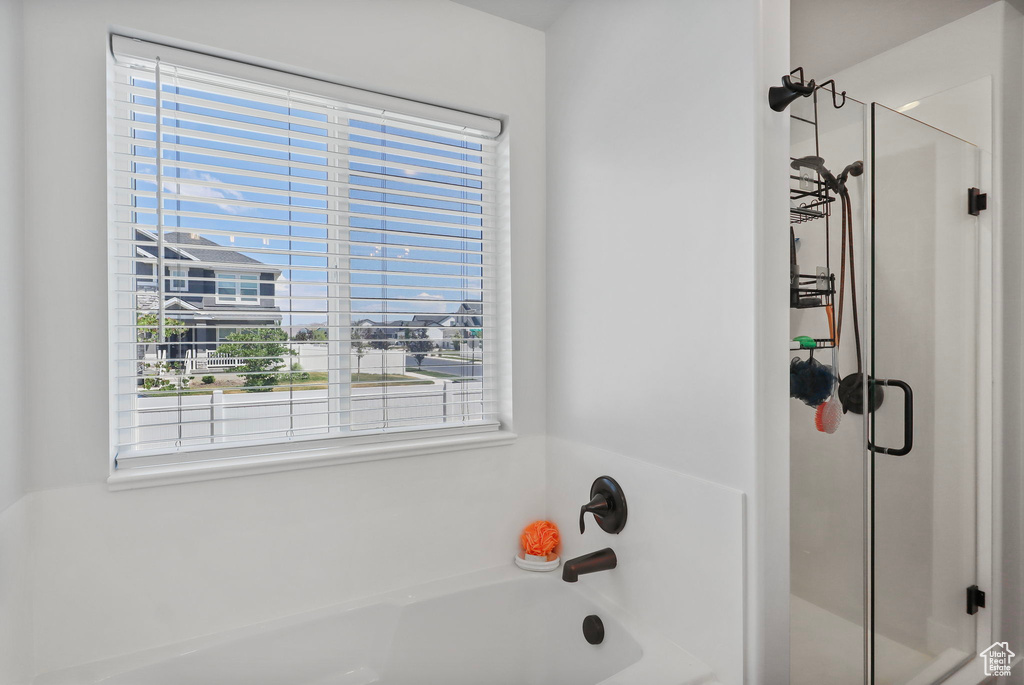 Full bathroom with a stall shower and a bath