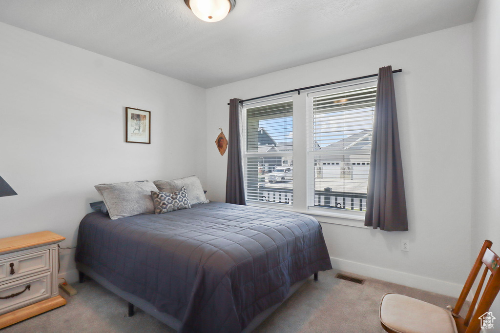 Bedroom featuring carpet floors and baseboards