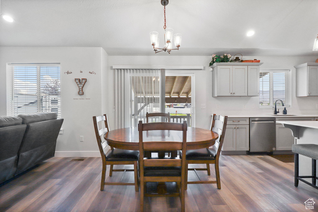 Dining room featuring a chandelier, dark wood-type flooring, and recessed lighting
