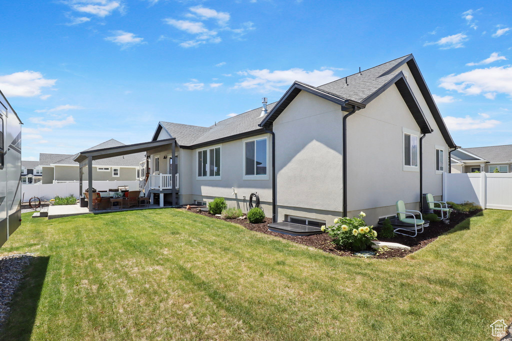 Back of house featuring a fenced backyard, a patio area, an outdoor hangout area, and stucco siding