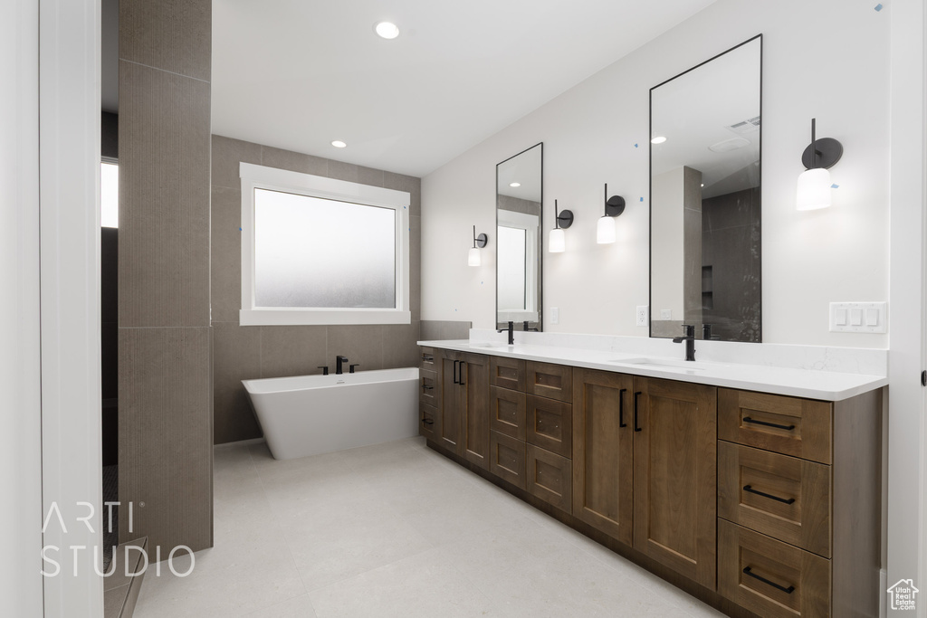 Full bathroom with double vanity and a freestanding tub