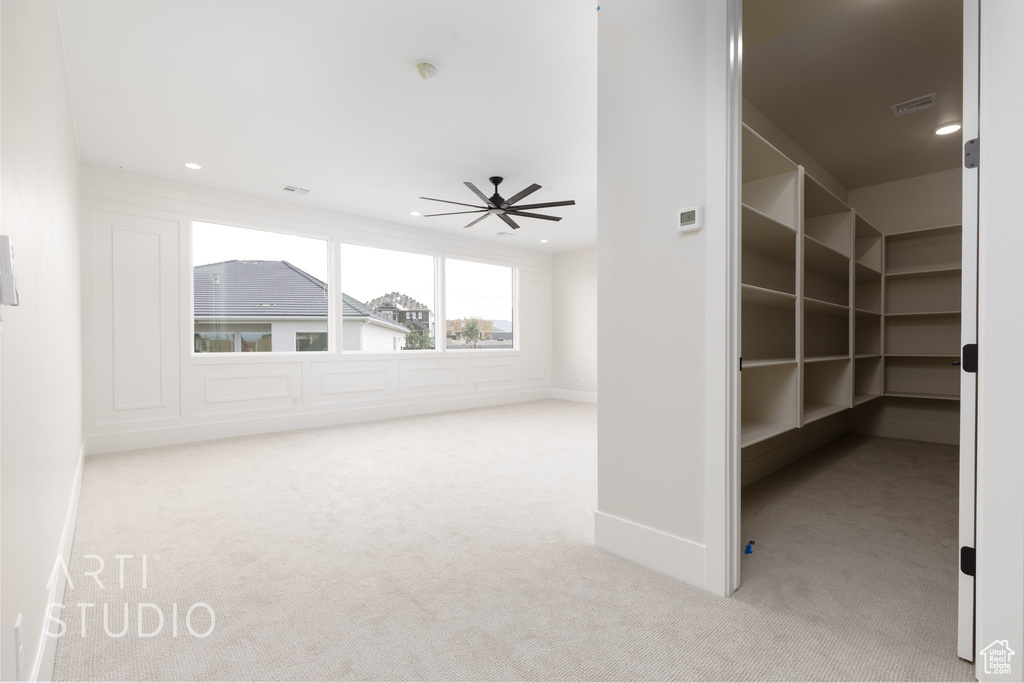 Interior space featuring carpet flooring, ceiling fan, recessed lighting, and baseboards