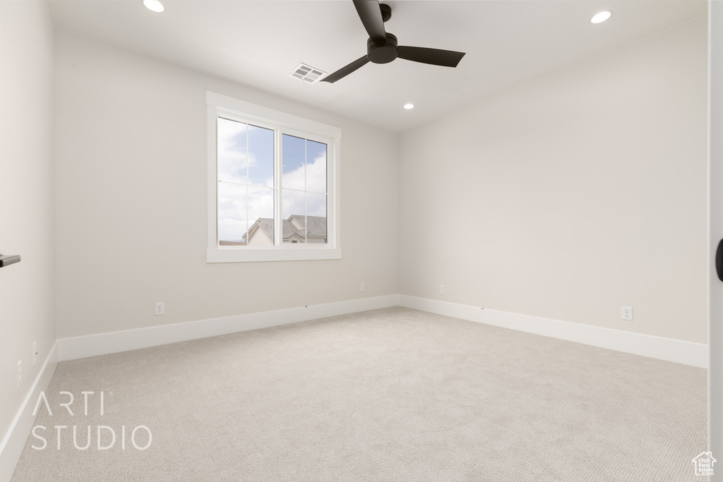Spare room featuring light carpet, a ceiling fan, recessed lighting, and baseboards