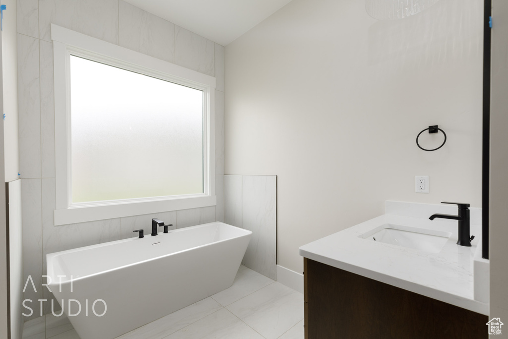 Full bathroom featuring a freestanding tub and vanity