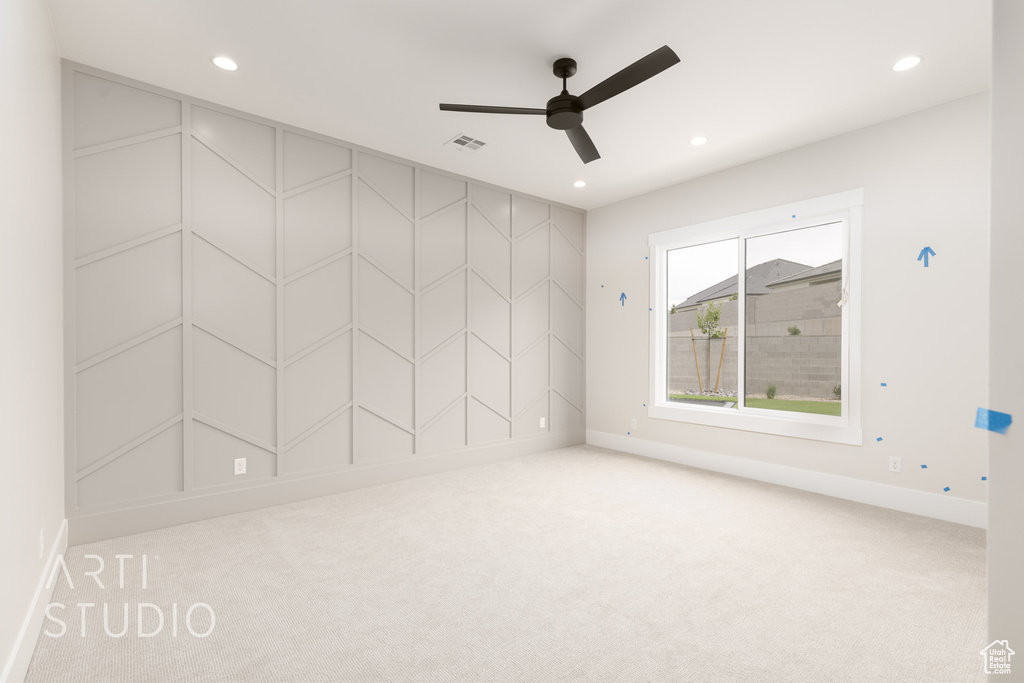 Carpeted empty room featuring ceiling fan, baseboards, and recessed lighting