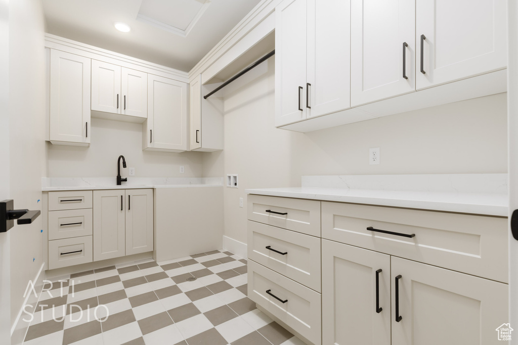 Laundry area featuring baseboards, cabinet space, hookup for a washing machine, and recessed lighting
