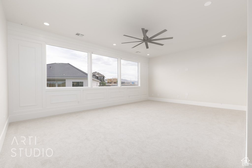 Spare room with carpet floors, recessed lighting, a ceiling fan, and baseboards