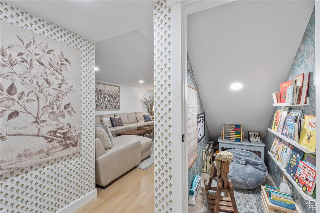 Bedroom featuring wood finished floors and lofted ceiling