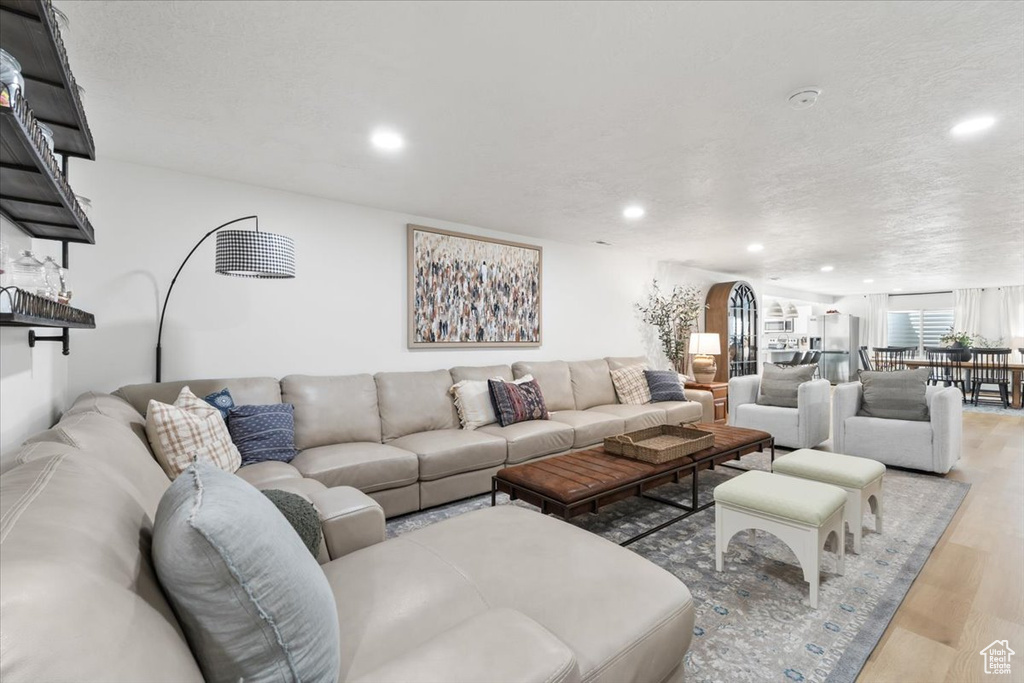 Living room with wood finished floors and recessed lighting