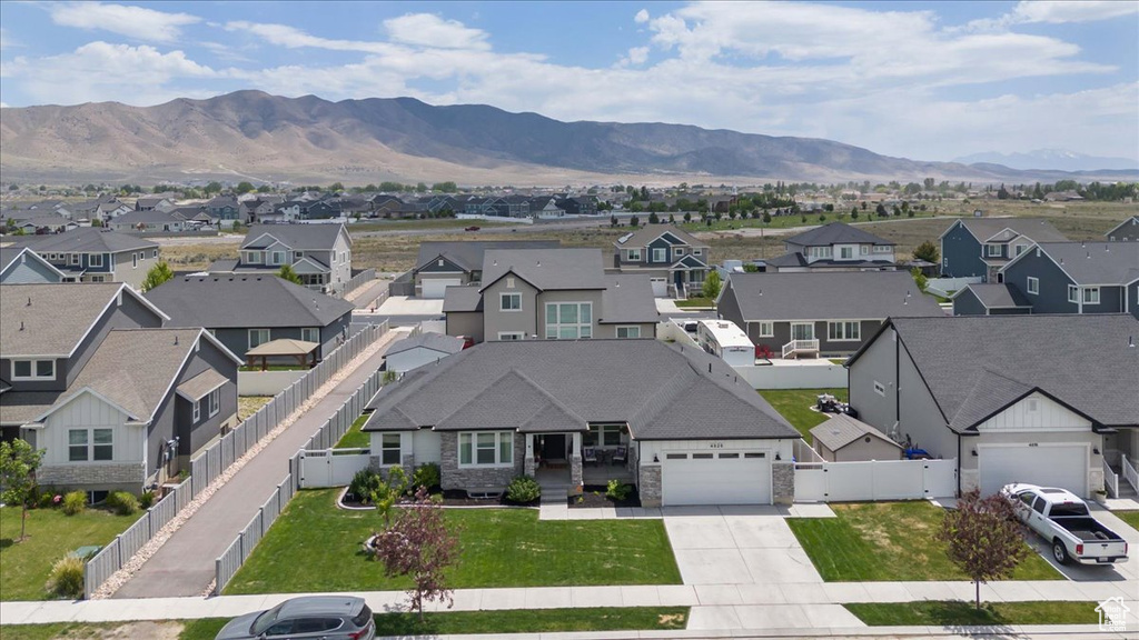 Aerial view of residential area featuring a mountainous background