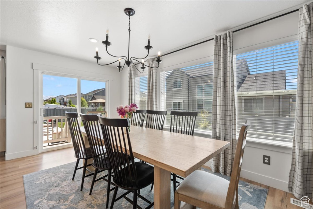 Dining area featuring a chandelier and wood finished floors