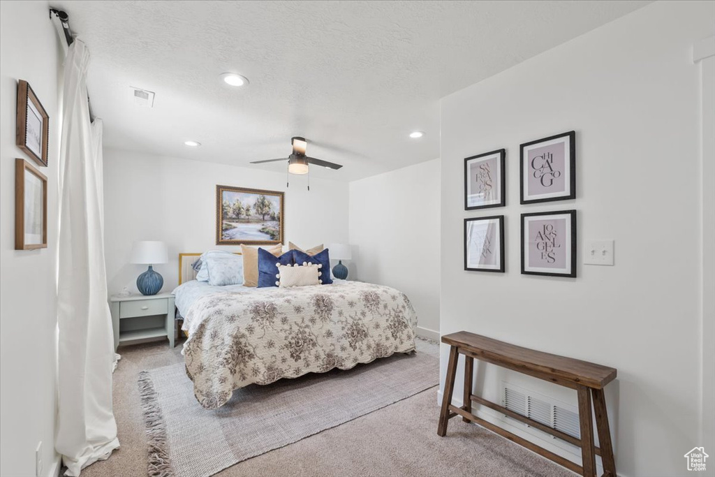 Bedroom with carpet flooring, recessed lighting, ceiling fan, and a textured ceiling