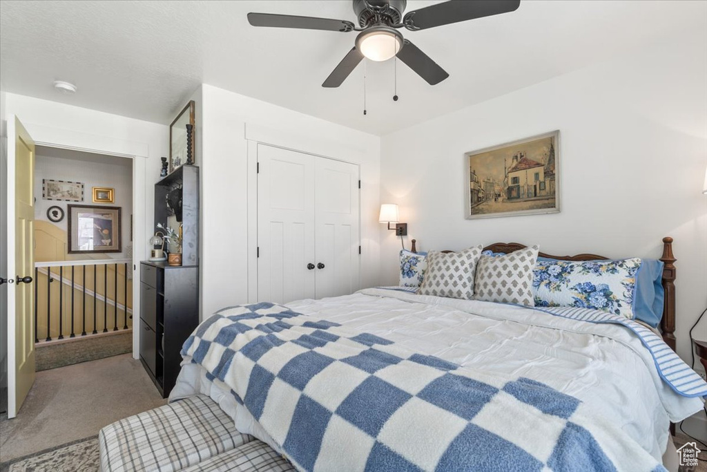 Bedroom featuring carpet flooring, a closet, and ceiling fan