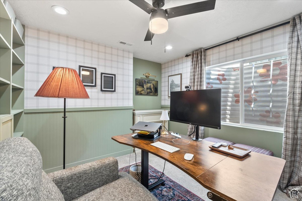 Office with wainscoting and ceiling fan