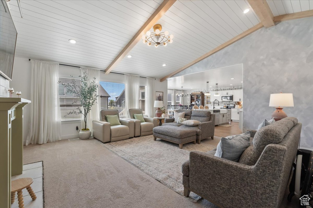 Living room with a chandelier and light colored carpet