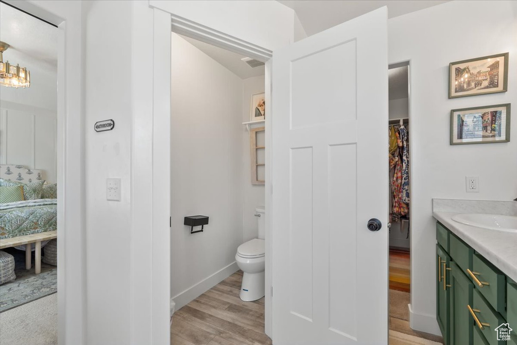 Full bath with vanity and wood finished floors