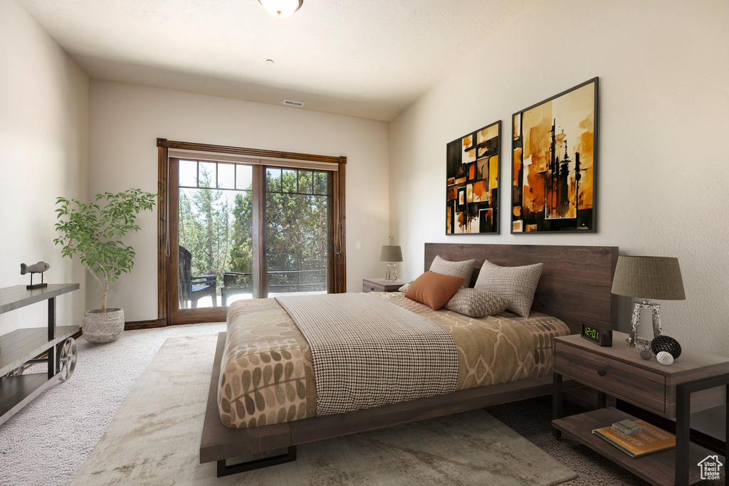 Bedroom with access to outside and carpet