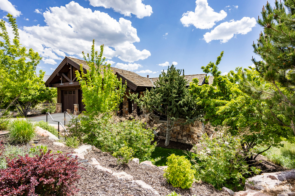 View of property exterior with stone siding