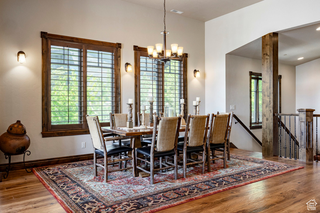 Dining space featuring a chandelier and wood finished floors