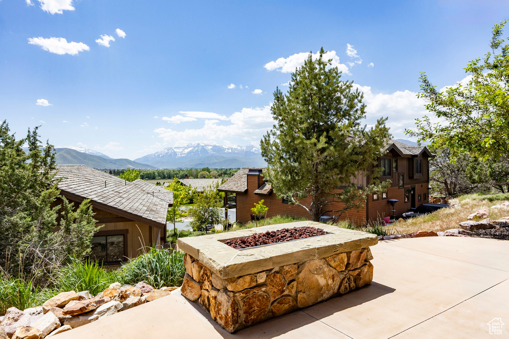 View of patio / terrace with an outdoor fire pit and a mountain view